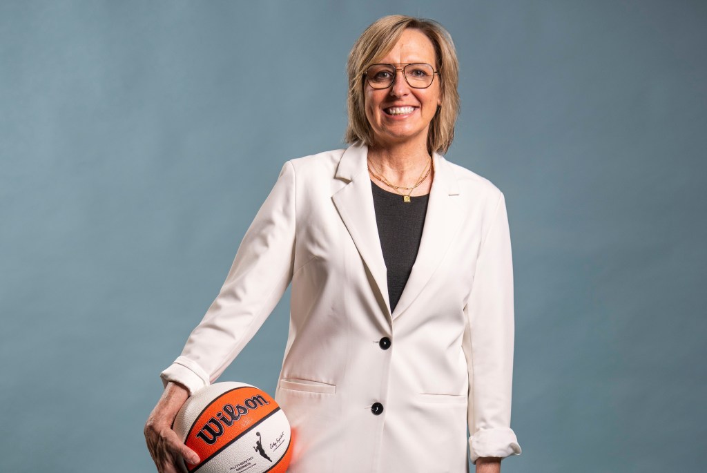 Former Indiana Fever general manager Amber Cox poses with a basketball.