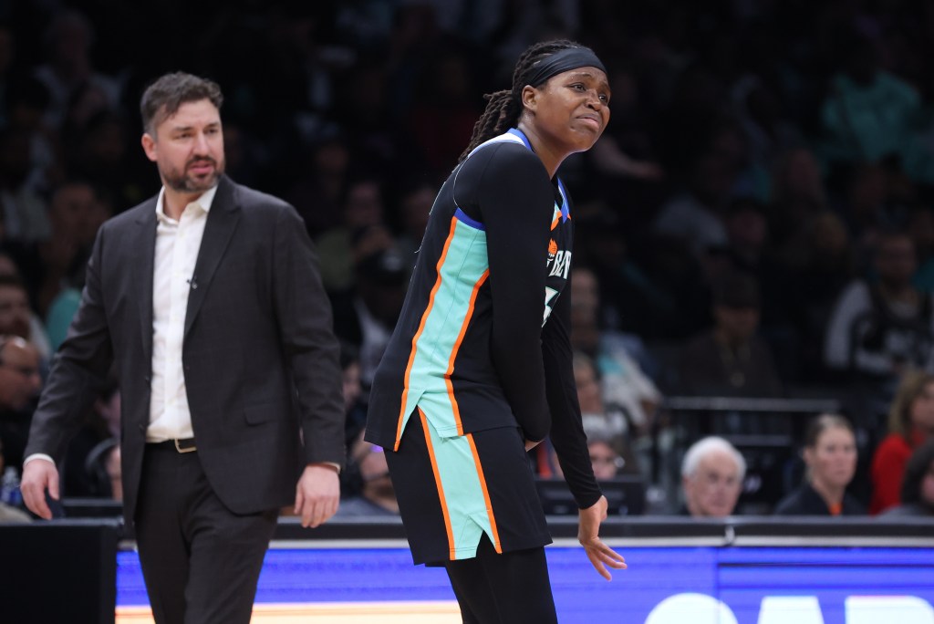 Jonquel Jones is upset about a call on the floor while her coach Chris DeMarco looks puzzled behind her.