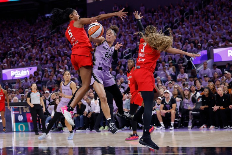 Golden State Valkyries guard Veronica Burton (22), passes the ball between Atlanta Dream forward Angel Reese and guard Jordin Canada (3) during the second quarter of game one of the 2026 WNBA Finals at Chase Center.