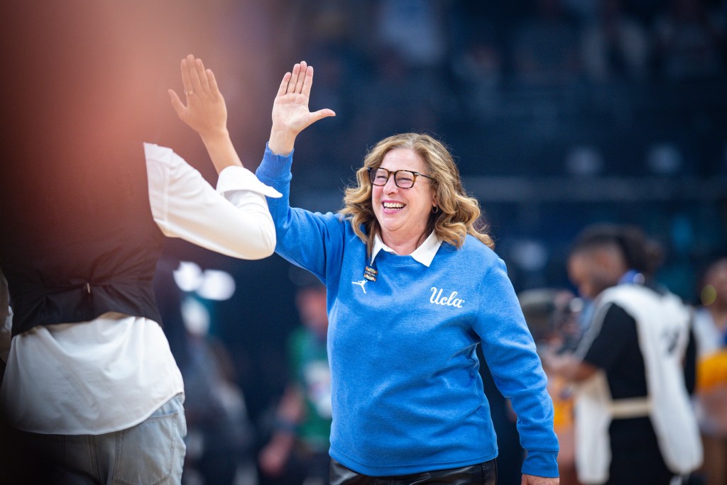 UCLA head coach Cori Close cheers with her team during the 2026 National Championship game.