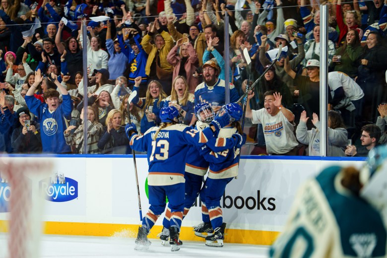 Vancouver Goldeneyes players celebrate a goal.