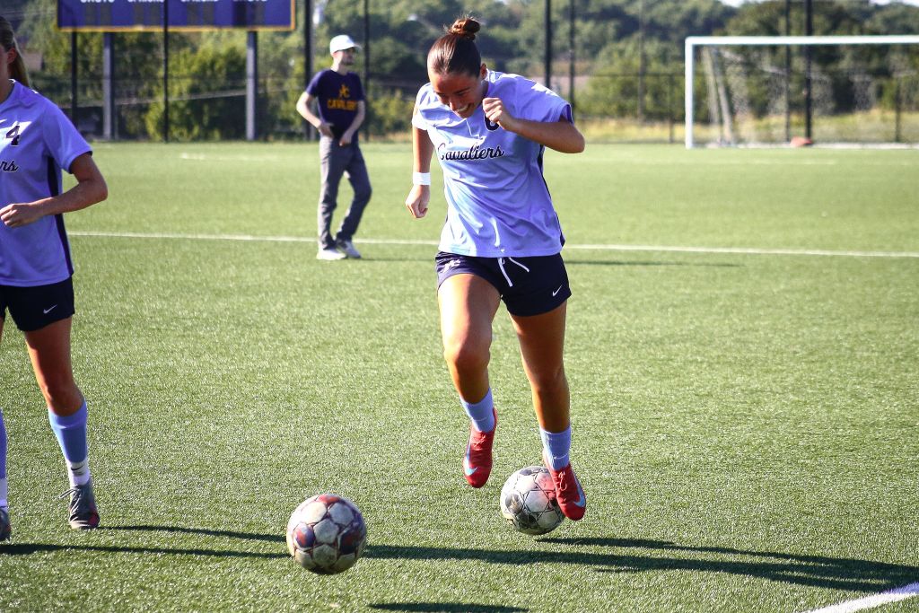 Johnson County Community College midfielder Flo Rigby practices alongside her teammates.