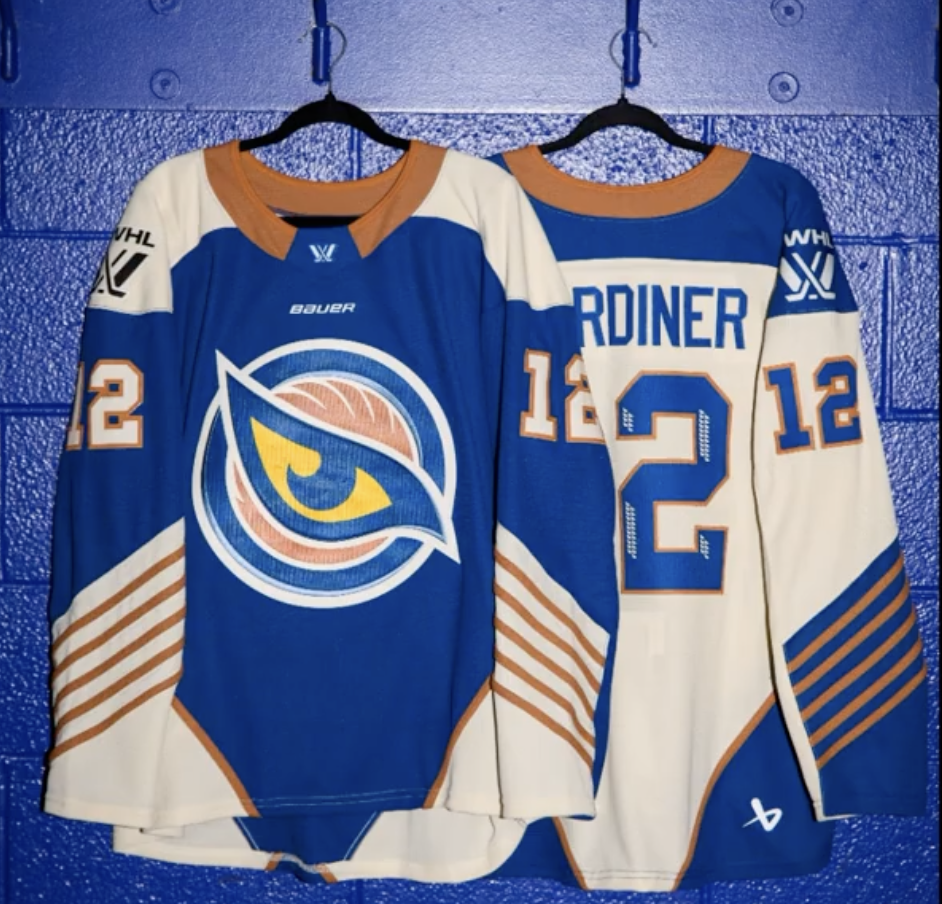 The new Vancouver Goldeneyes jerseys on hangers in front of a blue cinderblock wall.