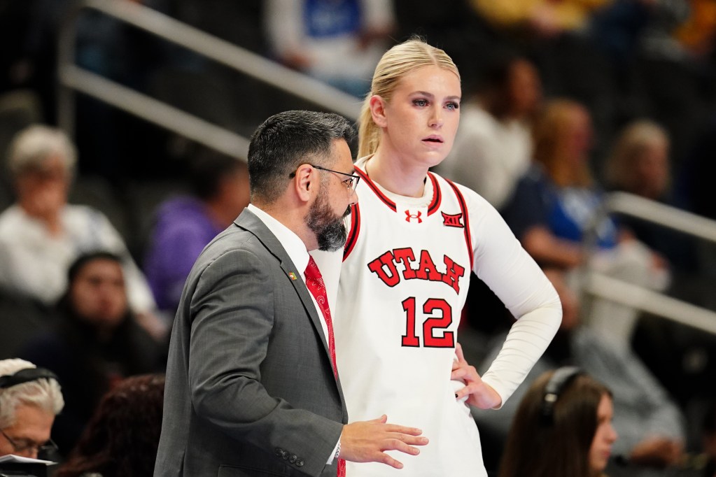 Utah head coach Gavin Petersen talks with center <a rel=